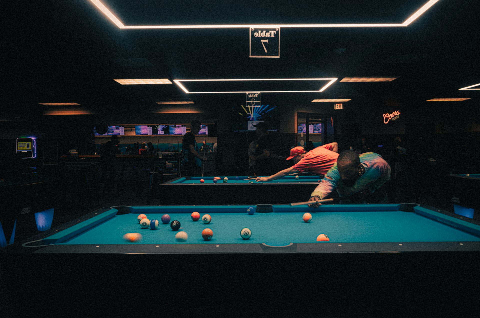 Busy billiards club environment during play